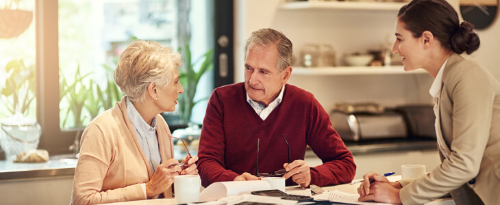 An older couple talks to lawyer about a life insurance trust