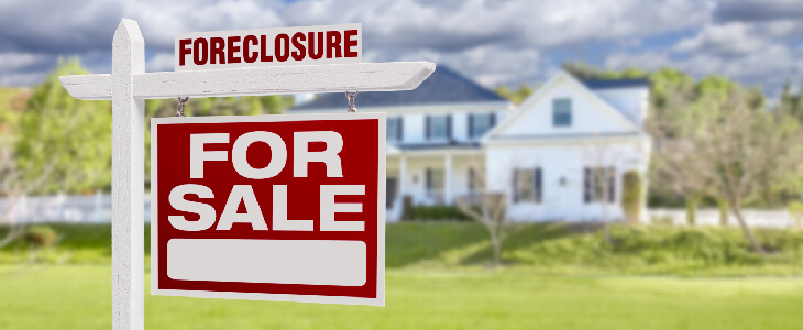 foreclosure for sale sign outside of a huge home