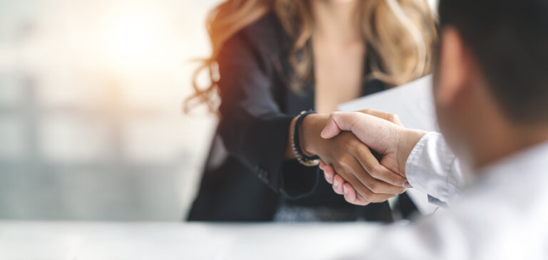 corporate business owner shaking hands with trustee