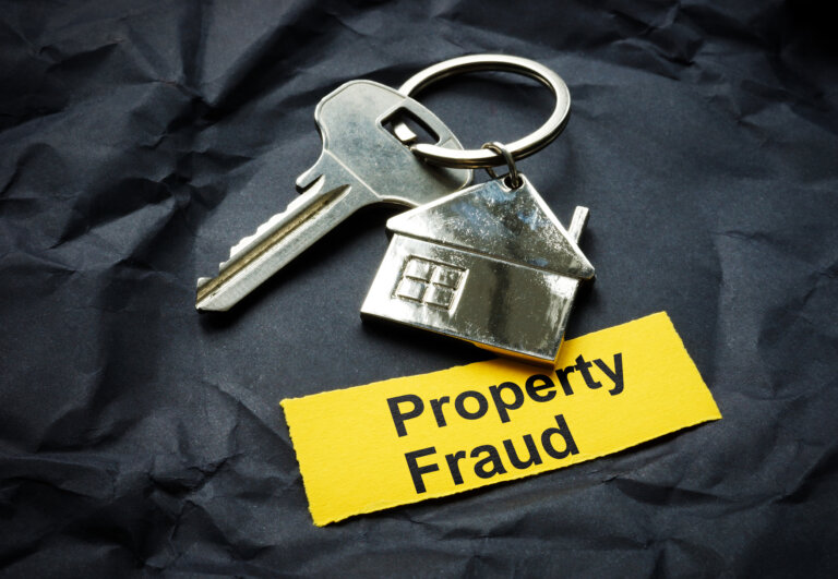 Key and a strip with inscription property fraud.