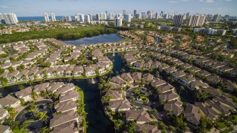 Ultra wide-angle view of Aventura, Golden Beach, and Sunny Isle Beach, Florida, on a sunny day in spring.