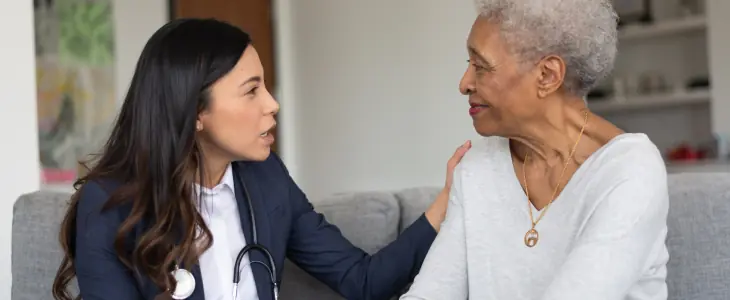 An older woman talks to a doctor