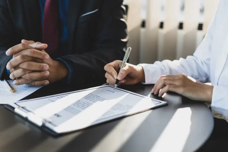 Estate planning attorney with client signing documents
