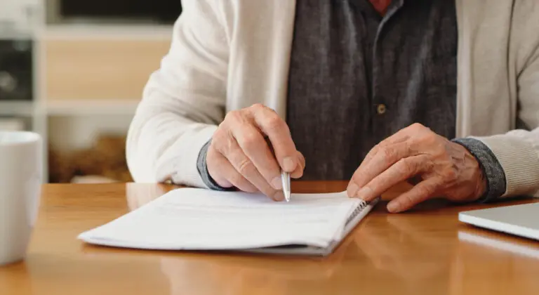 person writing on a document about estate planning in florida