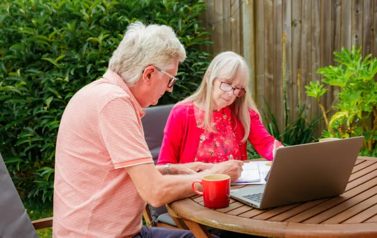an elderly couple behind the couple looking up beneficiary rights